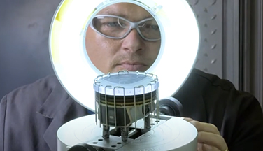 image of a man rating a piston head as part of a test