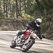 Motorcyclist driving on road.